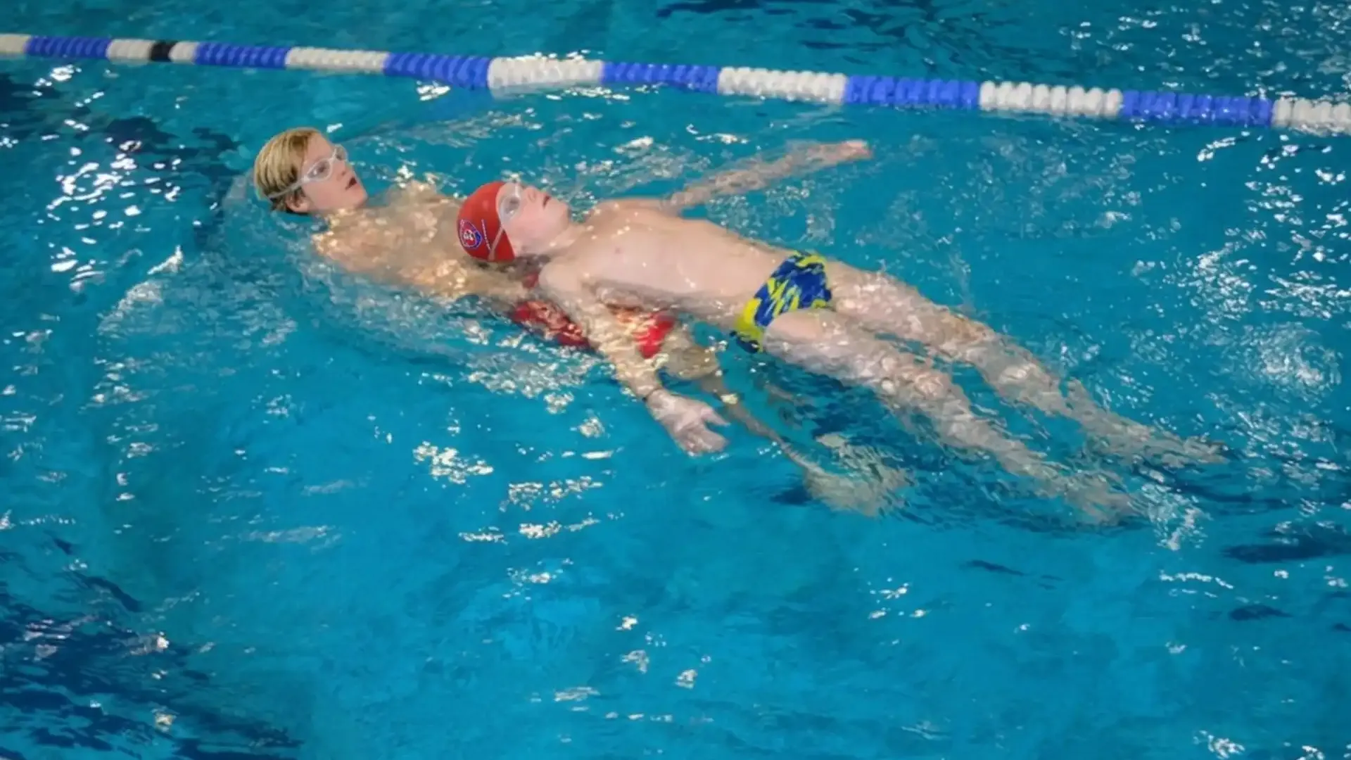 Kinder beim Schwimmkurs im Wasser